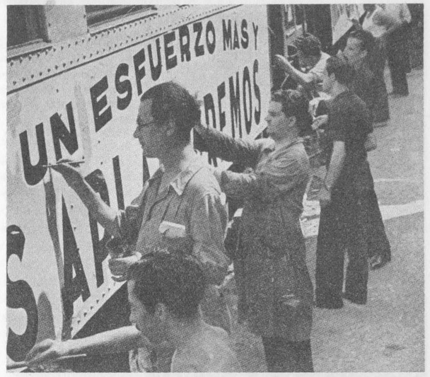 “Revolutionary slogans decorate the collectivized railroads.” “Working together, people paint slogans on a train.”